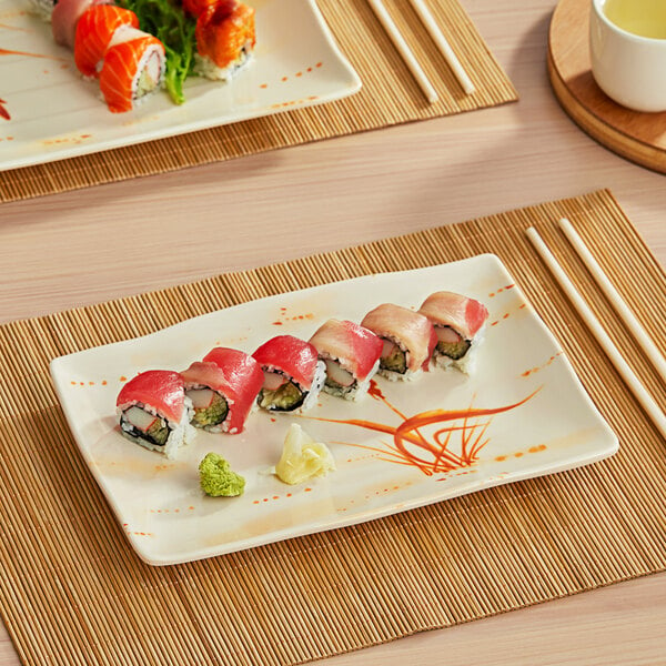 An Acopa Brassia rectangular melamine plate with sushi on a table.