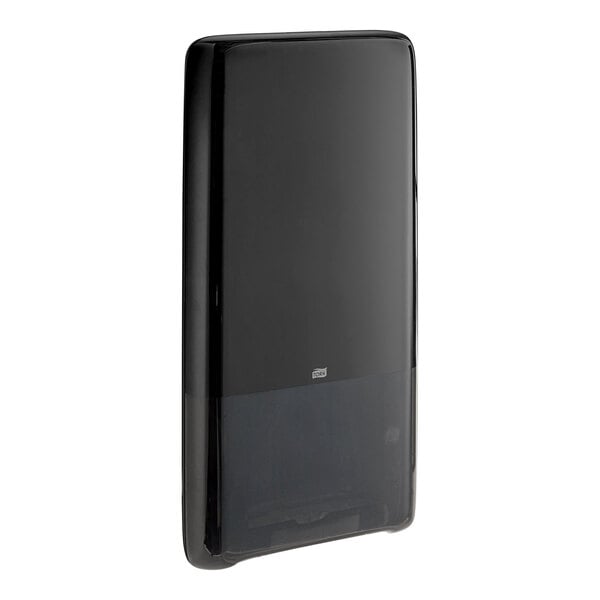 A black rectangular Tork PeakServe paper towel dispenser with a black cover on a white background.