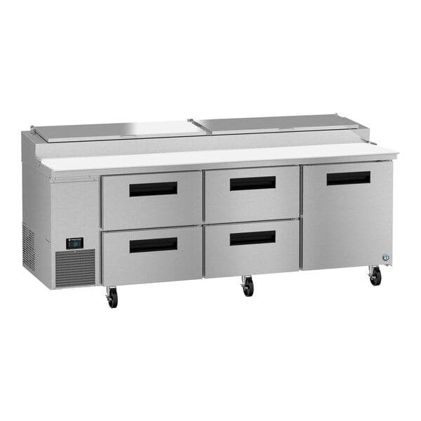 A stainless steel Hoshizaki pizza prep table counter with four drawers.