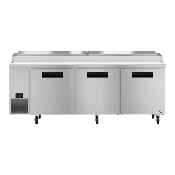 A Hoshizaki stainless steel refrigerated pizza prep table with three doors.