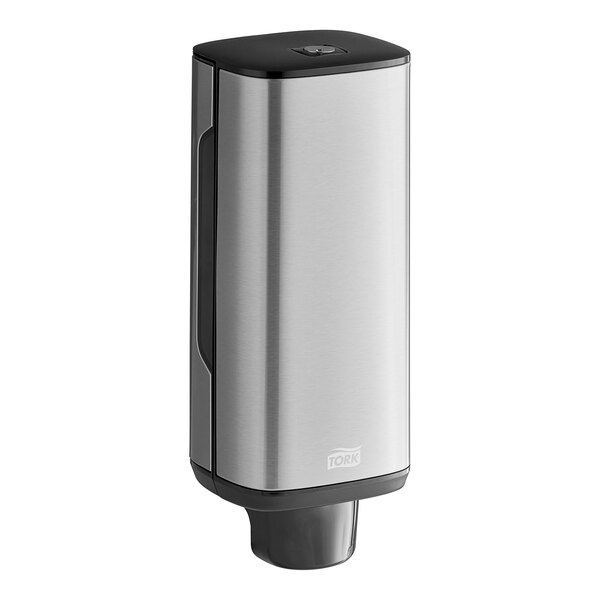 A silver stainless steel Tork manual foam soap dispenser.