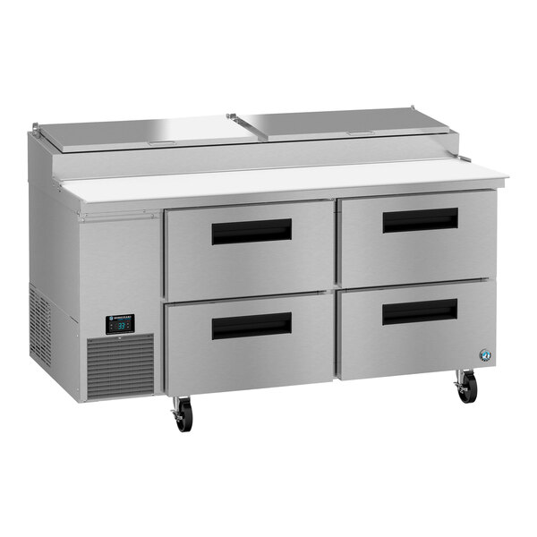 A Hoshizaki refrigerated pizza prep table with four drawers on a stainless steel counter.