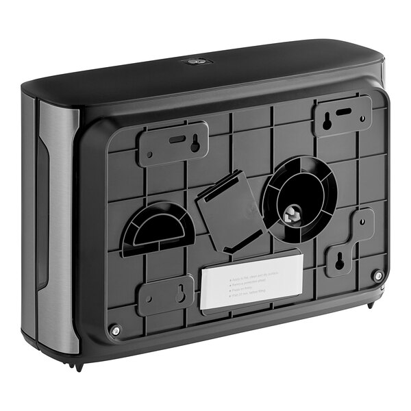 A black and silver rectangular Tork stainless steel double jumbo roll toilet paper dispenser with a white label.