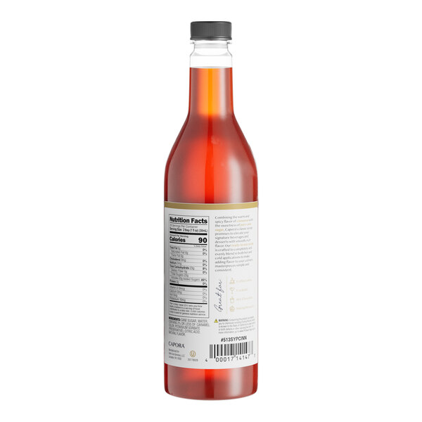 A close up of a Capora Cinnamon Flavoring Syrup bottle with a label.