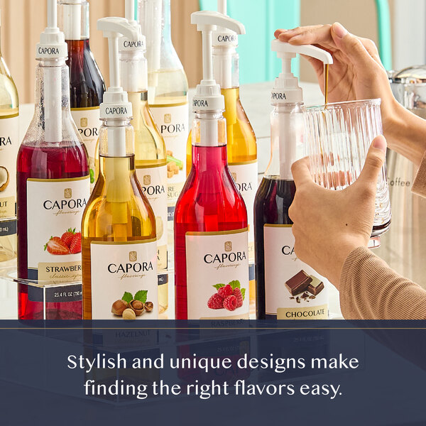 A bottle of Capora Cinnamon Flavoring Syrup with a pump dispenser among other flavored syrups.