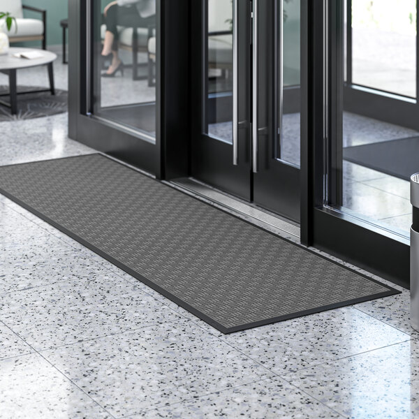 A black Lavex parquet entrance mat with a gray pattern on it.