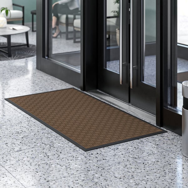 A brown Lavex parquet entrance mat on the floor.