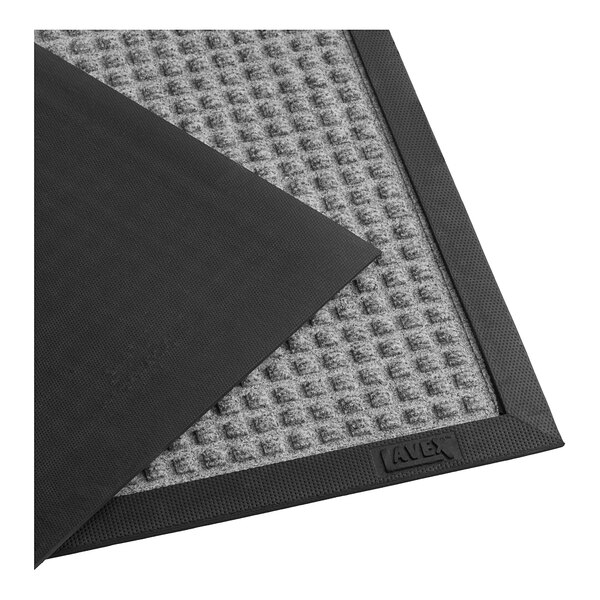 A pair of gray Lavex waffle entrance mats with a gray border.