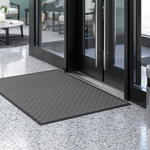 A gray Lavex parquet entrance mat on a marble floor.