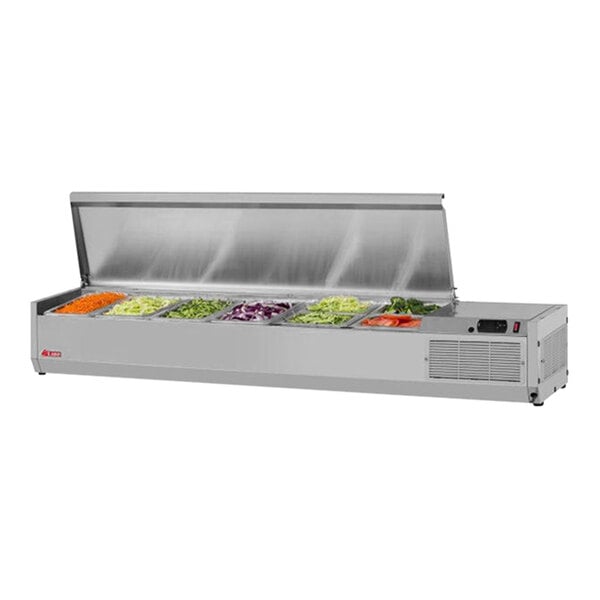 A Turbo Air stainless steel countertop salad prep table with food trays of vegetables.