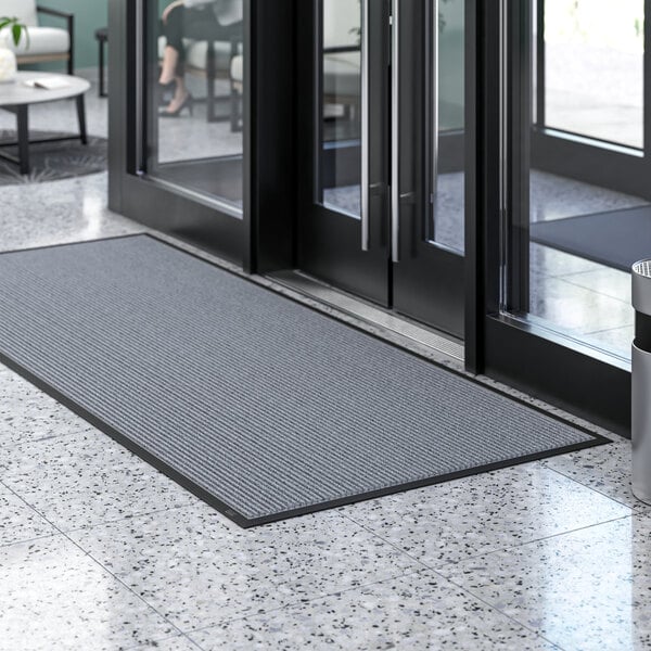 A Lavex gray indoor entrance mat on a floor.