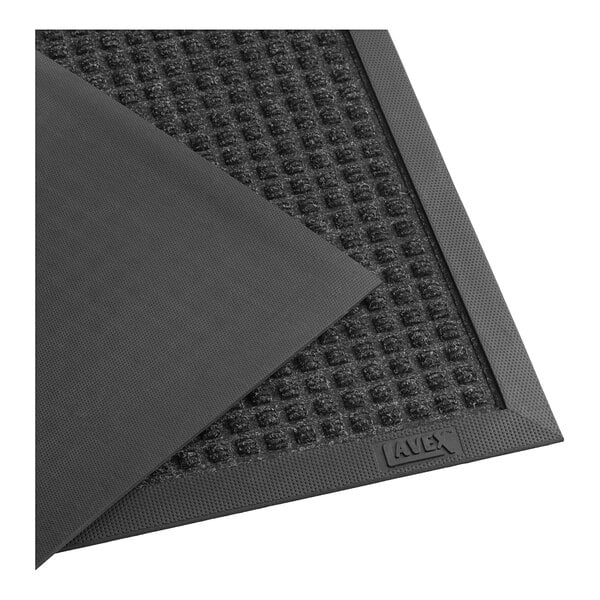 A close-up of a black Lavex waffle entrance mat with a rubber edge.