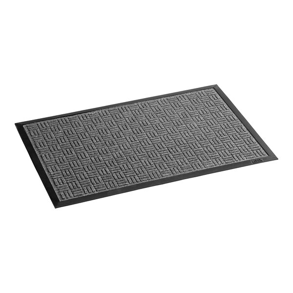 A grey rectangular doormat with a black border and geometric pattern.