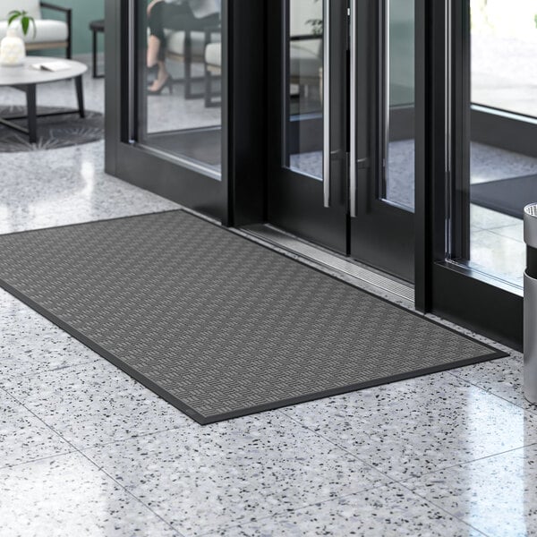 A black Lavex parquet entrance mat with a gray pattern on it.