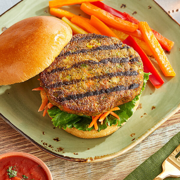 A Dr. Praeger's California Veggie Burger topped with lettuce and carrots on a plate.