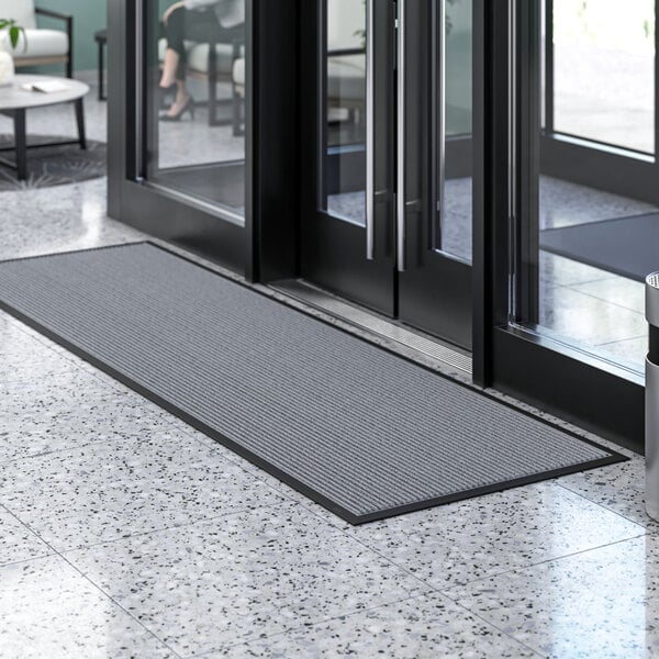 A grey Lavex Needle Rib entrance mat on a floor.