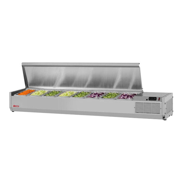 A Turbo Air stainless steel countertop salad prep table with food trays holding vegetables.
