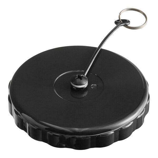 A black plastic Bunn brew thru lid with a metal ring attached.
