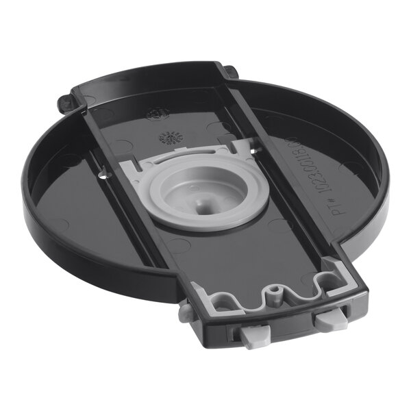 A black and grey circular cover assembly with a white label.
