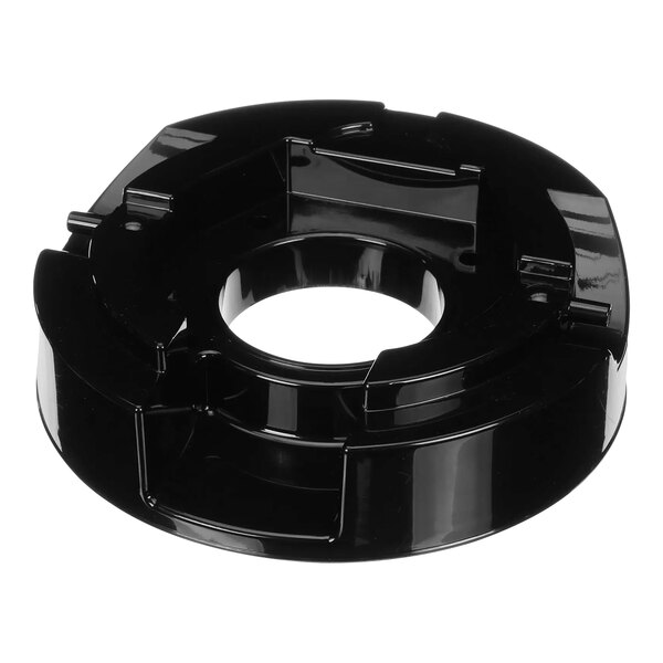 A black circular plastic top with a hole in the middle.