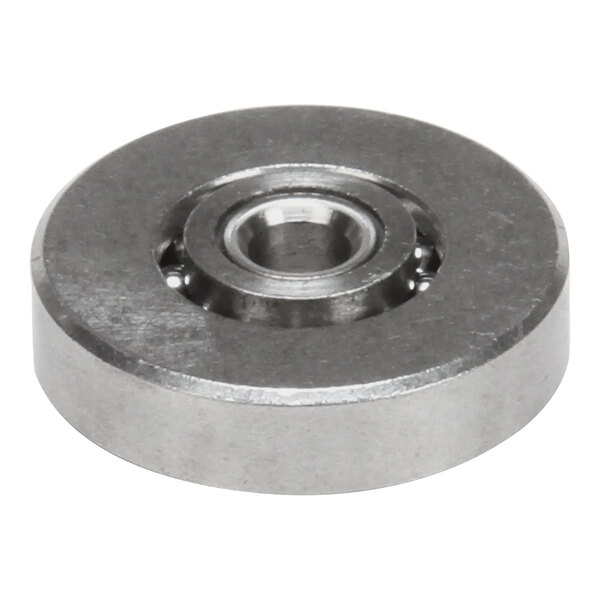 A Traulsen flat steel ball bearing with a hole in the center.
