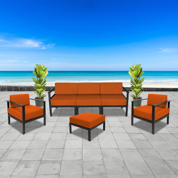 A BFM Seating Belmar outdoor armchair with an orange Sunbrella cushion on a white background.