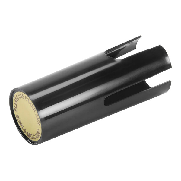 A black plastic tube with a yellow label over a round lid.