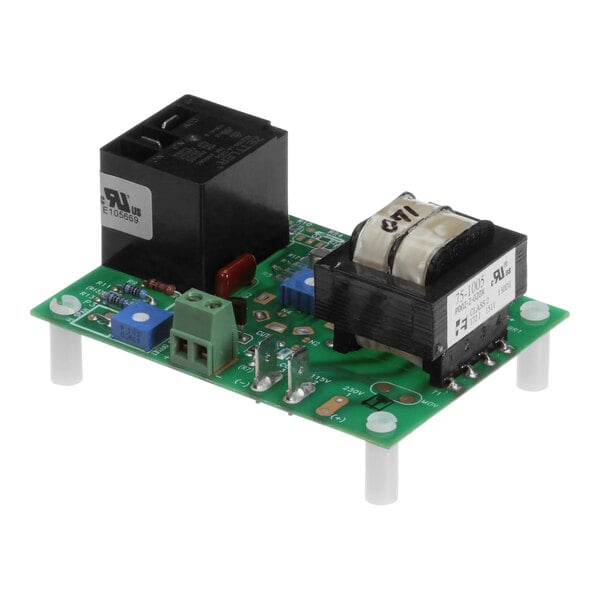 A close-up of a green Cleveland circuit board with a black square and white objects.