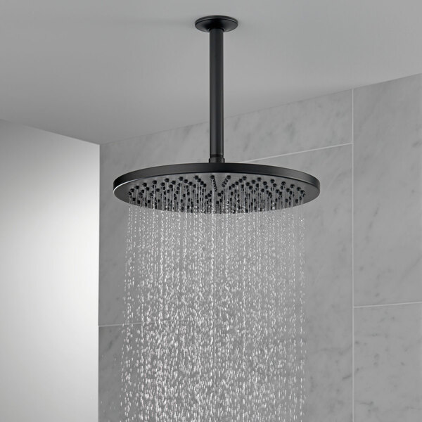 A Delta matte black round raincan showerhead with water running down from the ceiling.