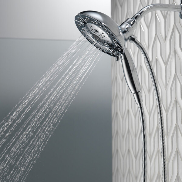 A Delta Lumicoat Chrome 2-in-1 H2Okinetic hand shower and showerhead with water running from it.