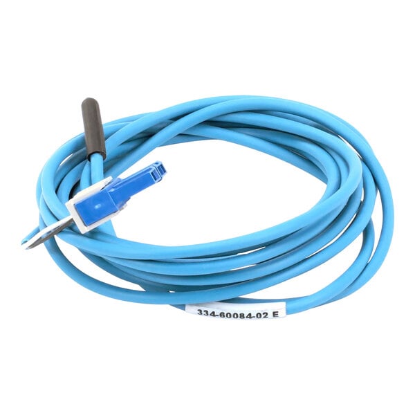 A close-up of a Traulsen blue coil sensor with a black connector.