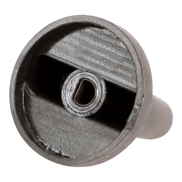 A close up of a metal Cleveland timer knob with a hole in it.