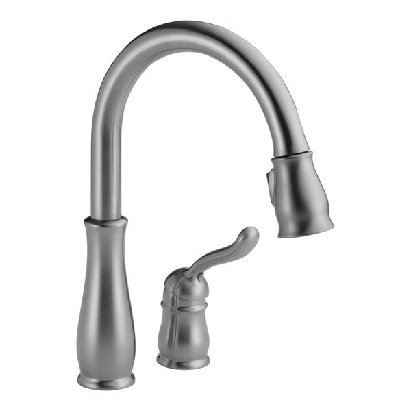 A Delta Leland kitchen faucet with pull-down sprayer and gooseneck spout.