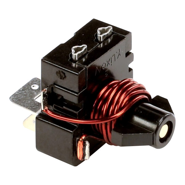 A close-up of a black Traulsen relay with red wires.