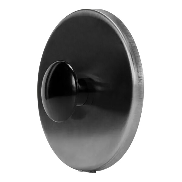A black metal plate with a round black knob on a round black object.