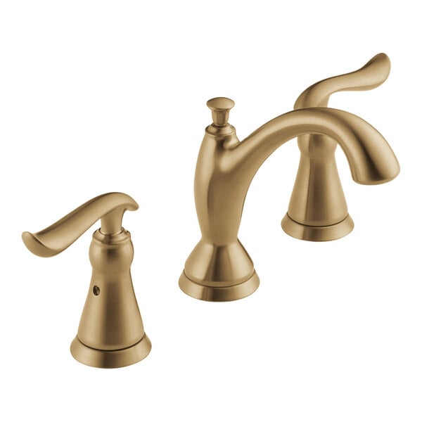 A close-up of a Delta widespread deck-mount faucet with two lever handles in a matte champagne bronze finish.
