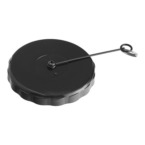 A black metal lid with a metal handle on a black circular object.
