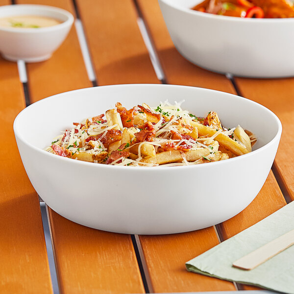 A white World Centric ZeroWare reusable bowl filled with pasta on a table.