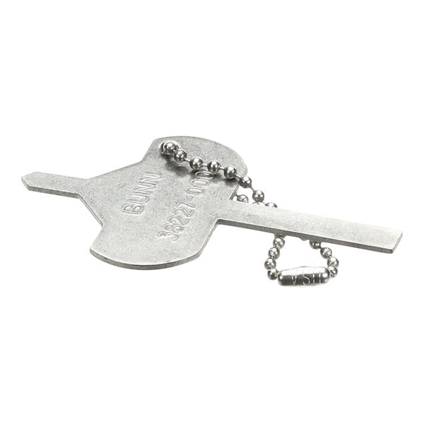A silver metal chain with a ball on the end attached to a silver metal key.