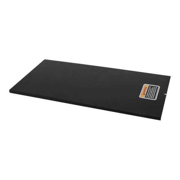 A black rectangular lid with orange decals on it.