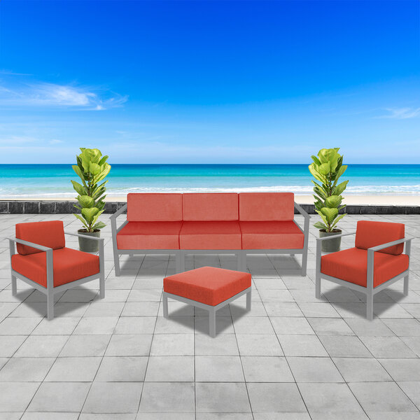 A BFM Seating Belmar sofa with red cushions on a white surface.