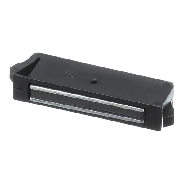 A black rectangular plastic magnet with a metal surface and a small hole in it.