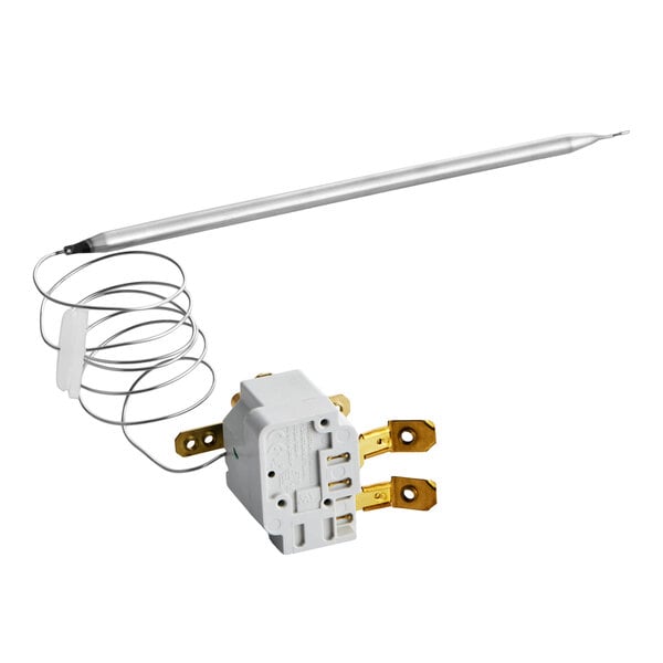 A white and metallic component with a coiled wire, a long probe, and brass connectors, likely part of an electrical or temperature control system.