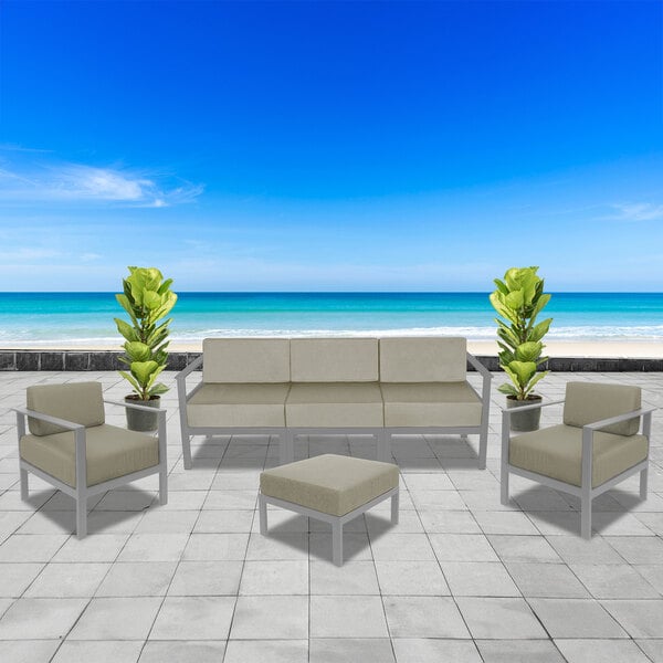 A BFM Seating Belmar gray frame sofa with white Sunbrella cushions on a patio.