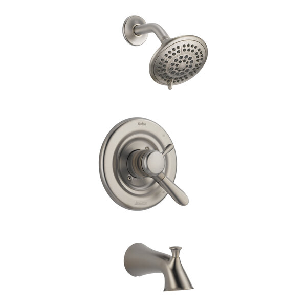 A close up of a stainless steel Delta faucet and shower head.