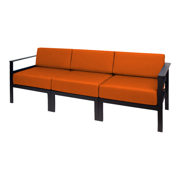 A BFM Seating Belmar sofa with orange Sunbrella cushions on a white background.