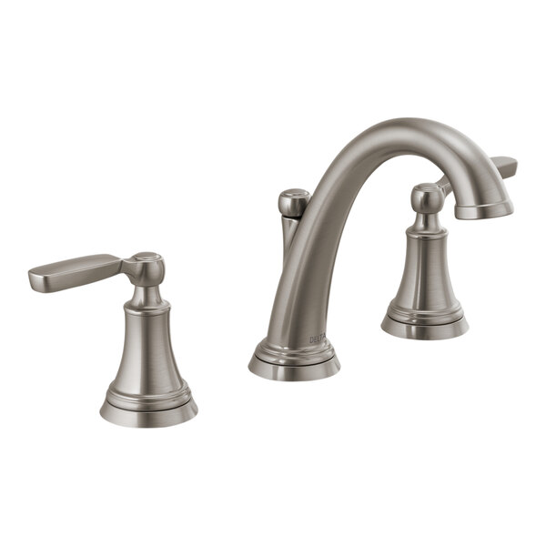 A Delta Woodhurst stainless steel widespread deck-mount faucet with lever handles.