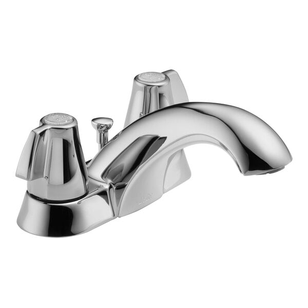 A close-up of a Delta chrome deck-mount lavatory faucet with blade handles.