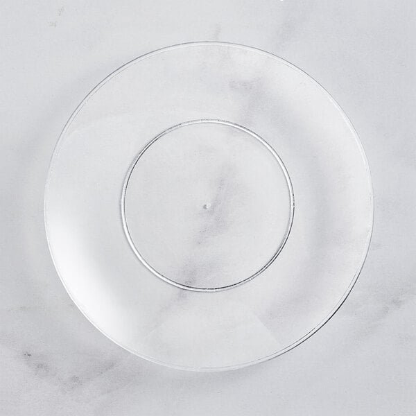 A clear plastic Visions coupe plate on a marble surface.