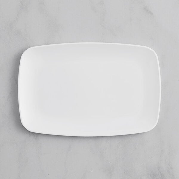 A white rectangular Visions plastic plate on a marble surface.